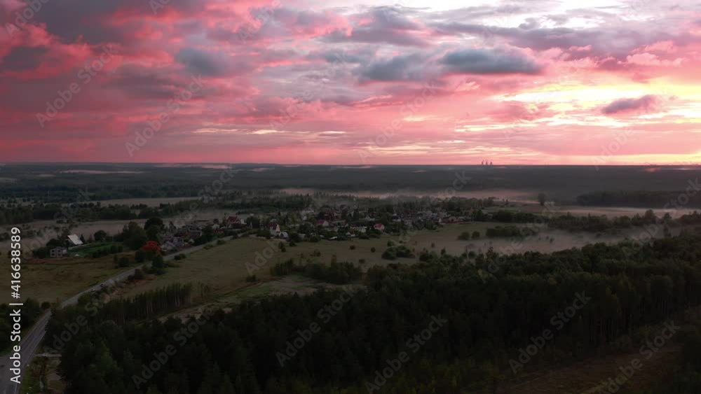 Aerial view of the rose of sunset clouds over rural scenery. Beautiful red and pink cloudscape and countryside from above Aerial view of the rose of sunset clouds over rural scenery. Beautiful red and pink cloudscape and countryside from above