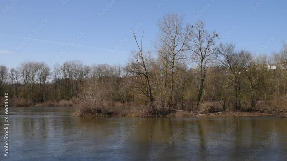 Winter landscape with Loire river, blue sky and trees Winter landscape with Loire river, blue sky and trees