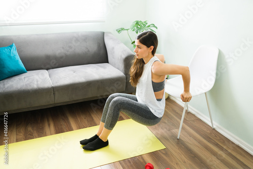 Healthy woman working out to strenghten her arms photo