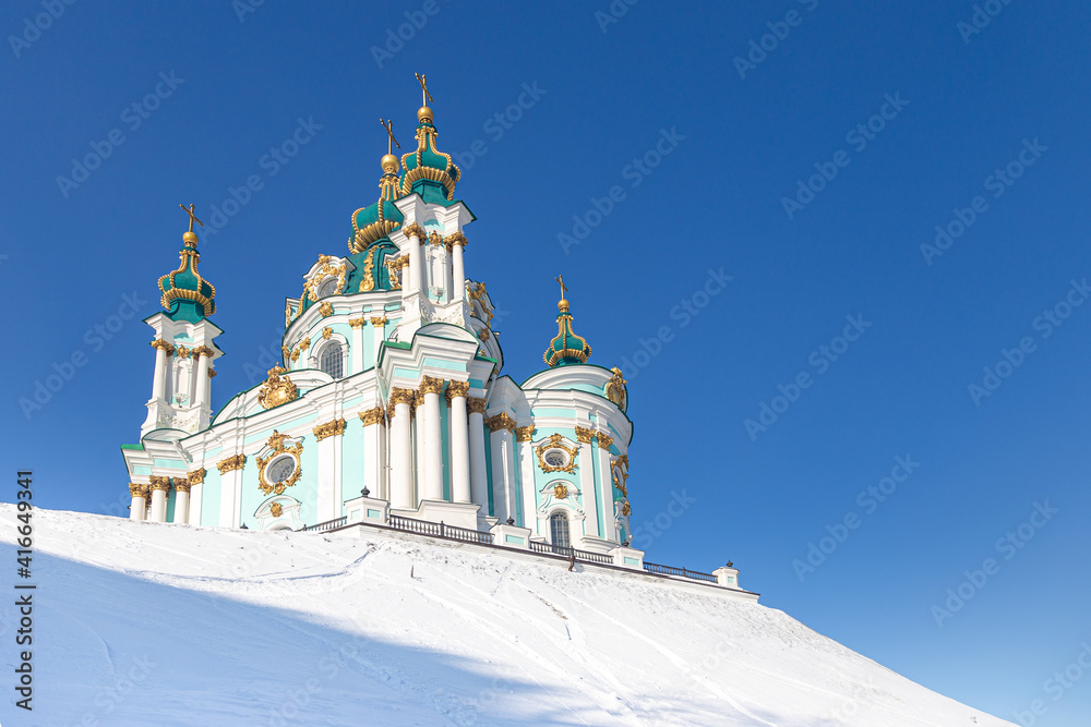 Kyiv, Ukraine. View of St. Andrew's Church on the snow-capped St. Andrew's Hill. Stauropegia of the Ecumenical Patriarch in Kyiv. Baroque designed by Rastrelli in 1747