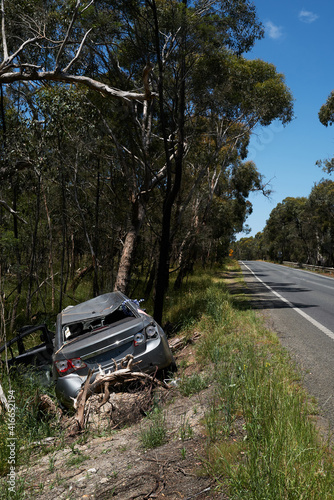 Smashed car left at the side of a country road