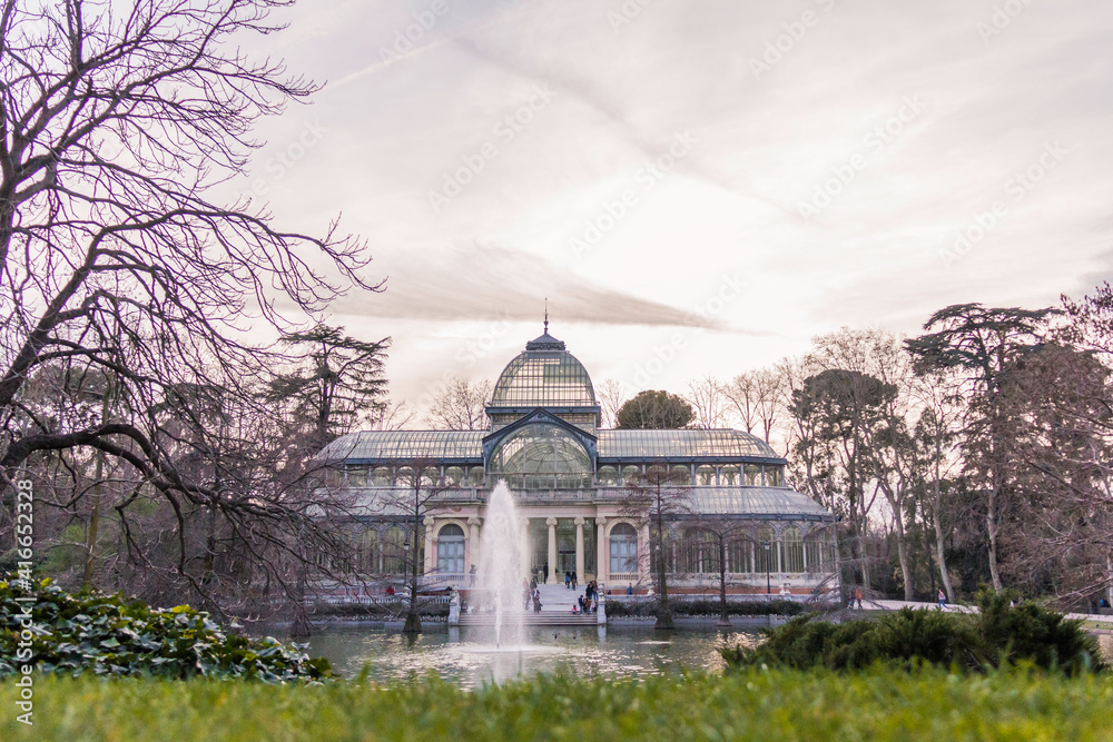 Fototapeta premium Madrid, Spain; March 7, 2019. Crystal Palace in Retiro Park with its fountain and lake in front.