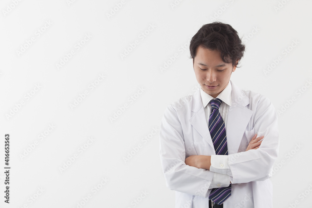 Asian doctor thinking about his patients Asian doctor thinking about his patients