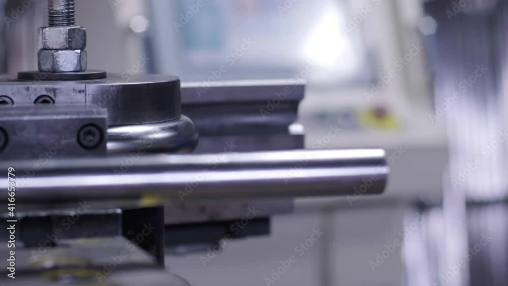Industrial bender equipment machine for metal pipe bending in the factory. Automatic metalworking machine for electronic turning metal pipe and cold bending at industrial hall at manufacturing plant