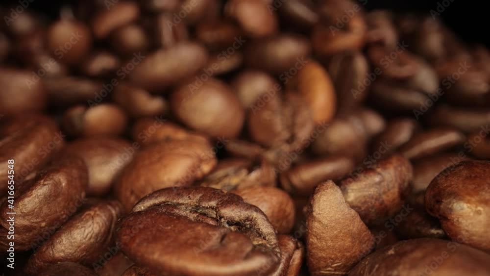 Freshly roasted Coffee Beans - sliding macro shot Freshly roasted Coffee Beans - sliding macro shot