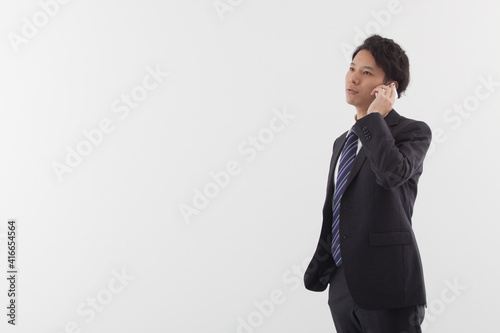 A young Asian business man talking on his phone