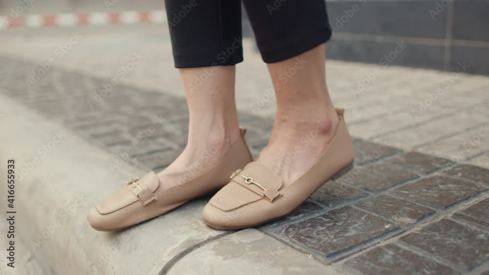 Successful young Asian business woman legs and feet detail in fashion office clothes walking through outdoors in urban modern city in the evening. Business on the go concept. Successful young Asian business woman legs and feet detail in fashion office clothes walking through outdoors in urban modern city in the evening. Business on the go concept.