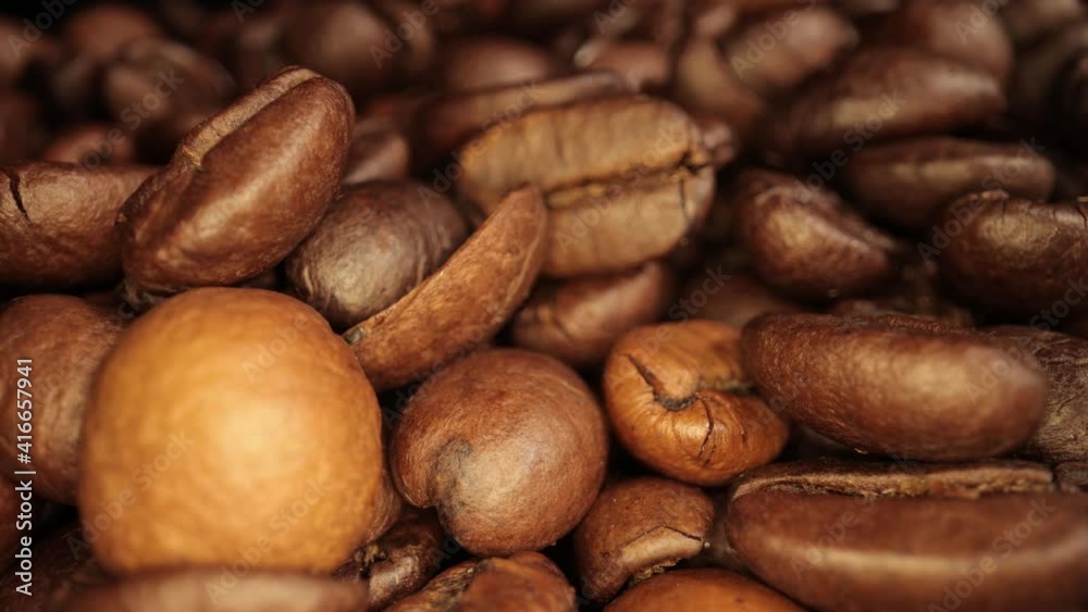 Flight over freshly roasted Coffee Beans - sliding macro shot