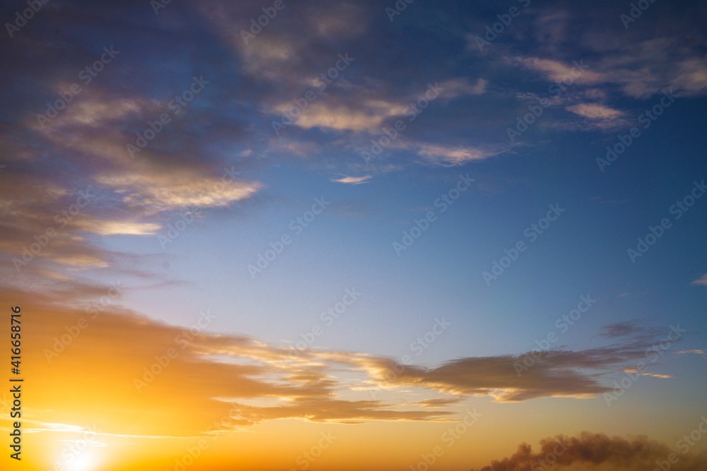 This image features a lovely, vibrant blue and gold sky as the sun is starting to come up over the landscape's horizon.