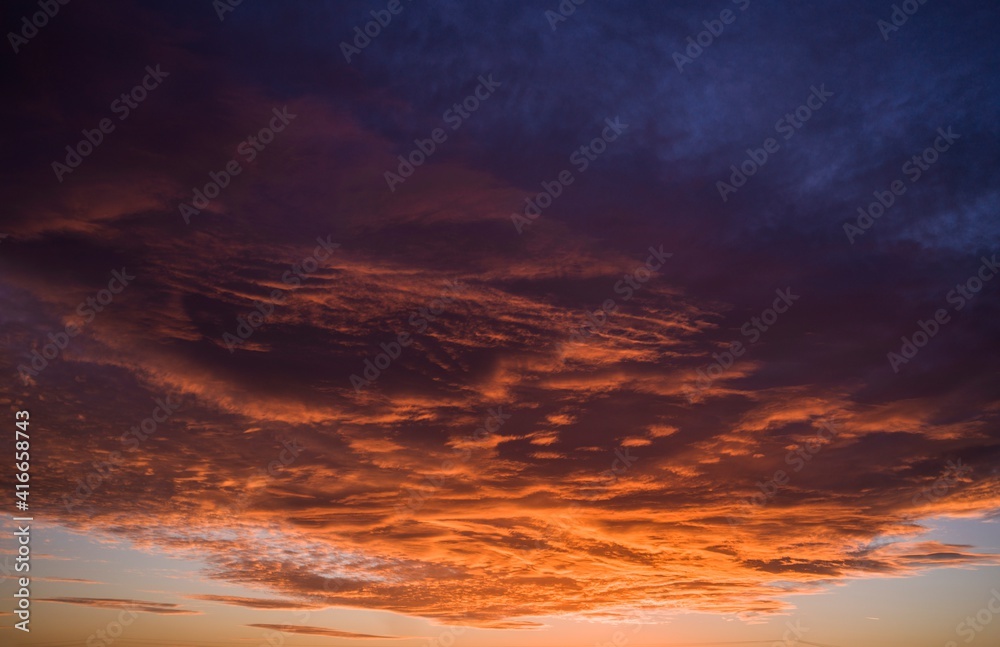This image shows an ominous sunset sky filled with huge orange clouds.
