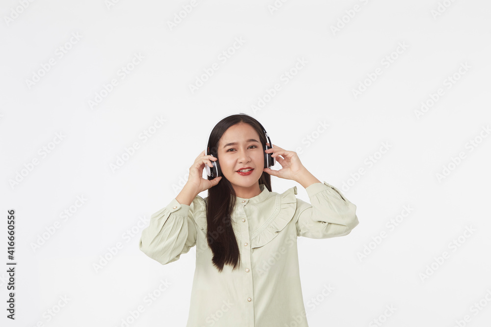 Joyful beautiful young Asian girl in headphones Joyful beautiful young Asian girl in headphones