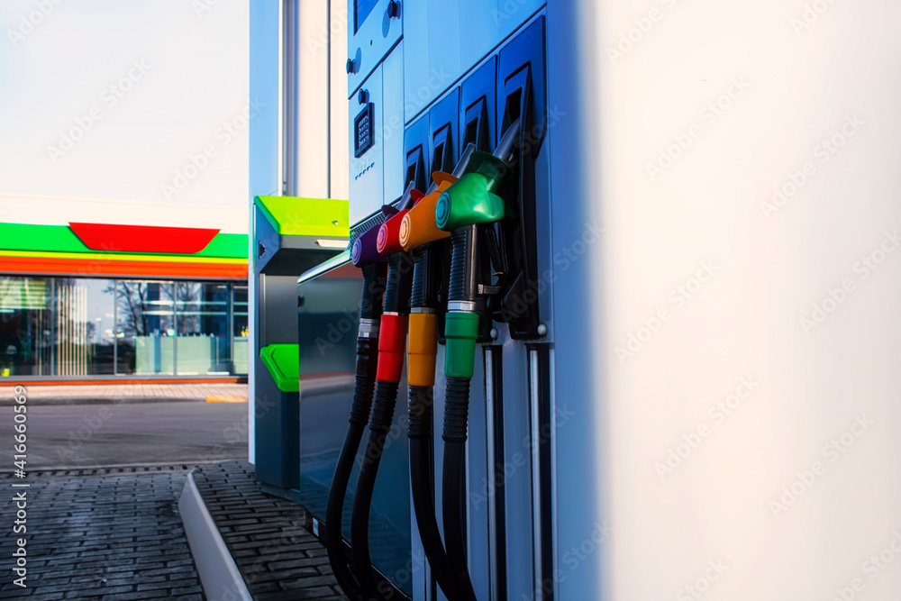 Gas station with diesel and gasoline fuel close-up against the background of the store. Gas station with diesel and gasoline fuel close-up against the background of the store.
