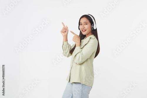 Joyful beautiful young Asian girl in headphones
