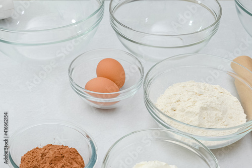 Chocolate cake recipe. Ingredients close up on kitchen table