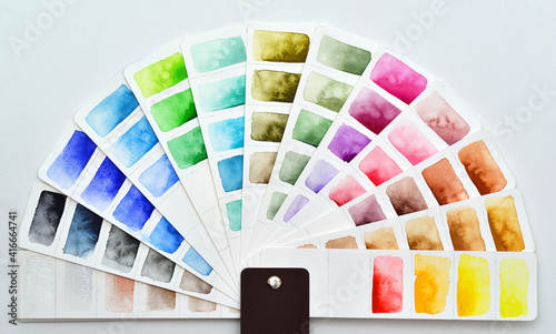 The color palette is a semicircle made of white watercolor paper with painted rectangles. 