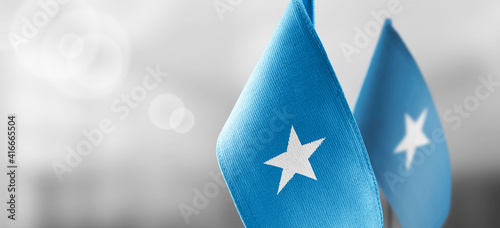 Small national flags of the Somalia on a light blurry background