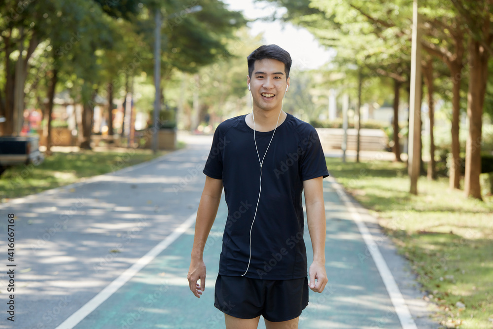 A young man walks outdoor as workout A young man walks outdoor as workout