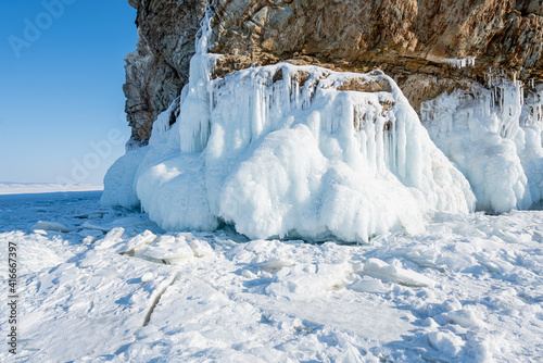 Snow on the Frozen Baikal Lake with mountains on the background. © Иван Грабилин