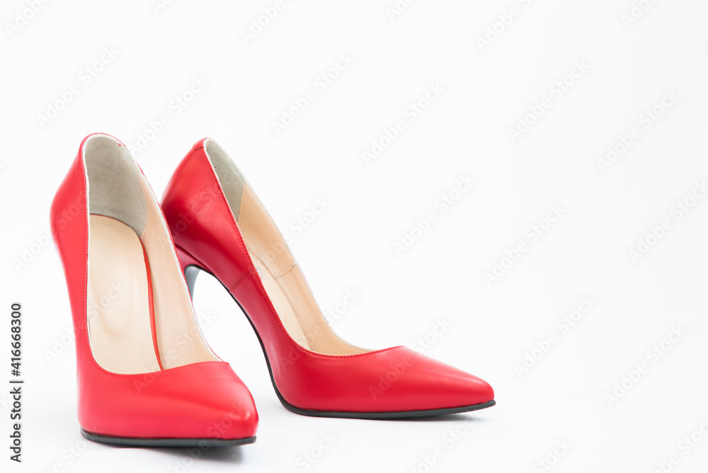 High-heeled shoes in red. Sexy shoes. White background. There is space for text High-heeled shoes in red. Sexy shoes. White background. There is space for text