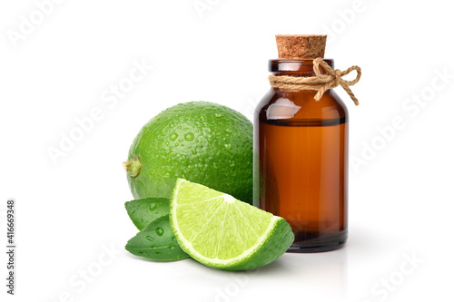 Green lime essential oil with fruit  and sliced isolated on white background.