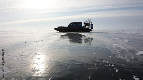 Hovercraft on frozen icy surface in the middle of the Baikal lake, Russia. Windy winter weather
