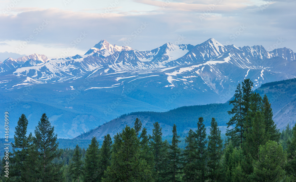 Snow capped mountain peaks in morning light, summer travel	