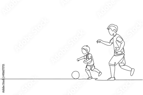 One single line drawing young dad running and playing football soccer with his son in public field park vector graphic illustration. Happy family parenting concept. Modern continuous line draw design