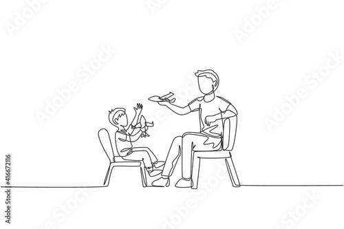 One single line drawing young dad and his son sitting on chair and playing airplane toy together at home vector graphic illustration. Happy family bonding concept. Modern continuous line draw design