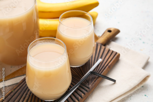Glasses with tasty banana juice on table