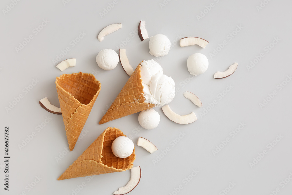 Waffle cones with tasty coconut ice cream on light background Waffle cones with tasty coconut ice cream on light background