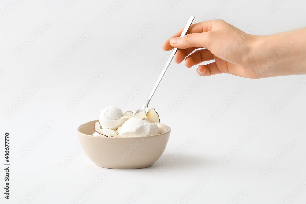Bowl with tasty coconut ice cream on white background Bowl with tasty coconut ice cream on white background