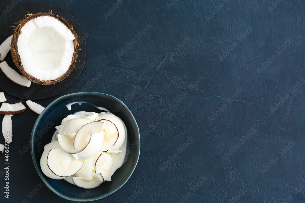Bowl with tasty coconut ice cream on dark background Bowl with tasty coconut ice cream on dark background