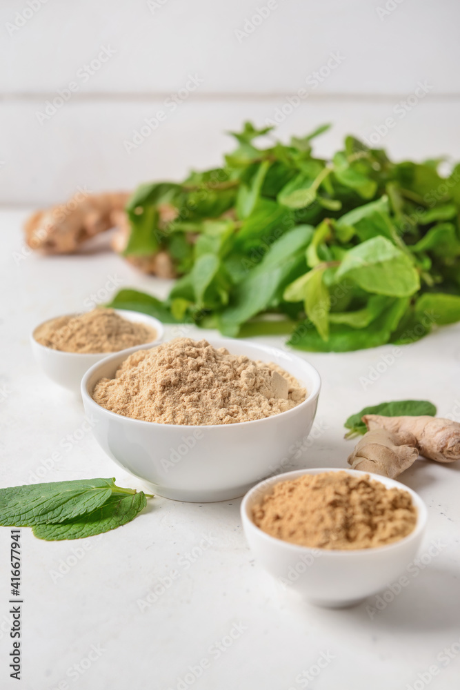 Composition with ginger powder on light background Composition with ginger powder on light background