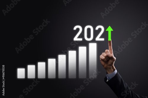 Business development to success and growing growth year 2021 concept.Plan business growth graph in year 2021 concept.Businessman plan and increase of positive indicators in his business