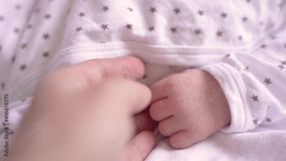 Slow motion video of a mother taking her newborn baby by the hand, full HD Slow motion video of a mother taking her newborn baby by the hand, full HD