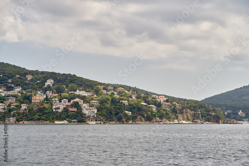 Island shoreline with buildings and trees view from water