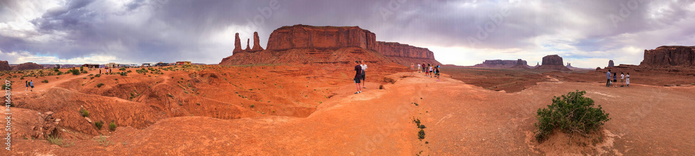 MONUMENT VALLEY, AZ - JUNE 30, 2019: Tourists visit beautiful landscape at sunset - Panoramic view MONUMENT VALLEY, AZ - JUNE 30, 2019: Tourists visit beautiful landscape at sunset - Panoramic view