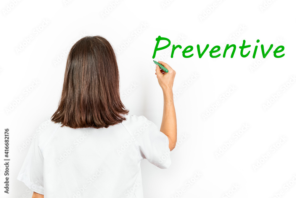 Doctor with mask writing the word preventive with a marker pen green Doctor with mask writing the word preventive with a marker pen green