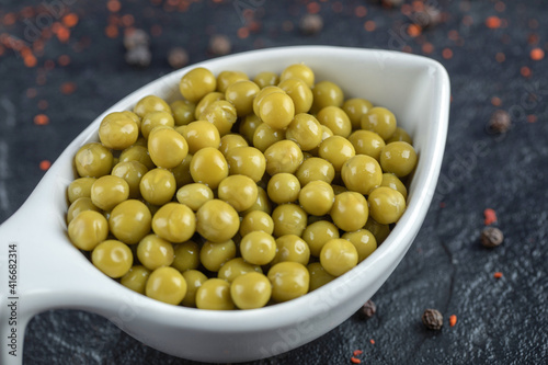 Close up view of white bowl full with green olives