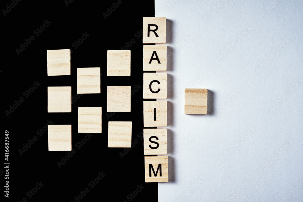 Many wooden blocks separated from one with word racism. Concept of racism and misunderstanding between people, prejudice and discrimination Many wooden blocks separated from one with word racism. Concept of racism and misunderstanding between people, prejudice and discrimination