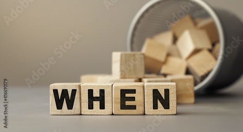 when - word concept from wooden blocks on desk photo