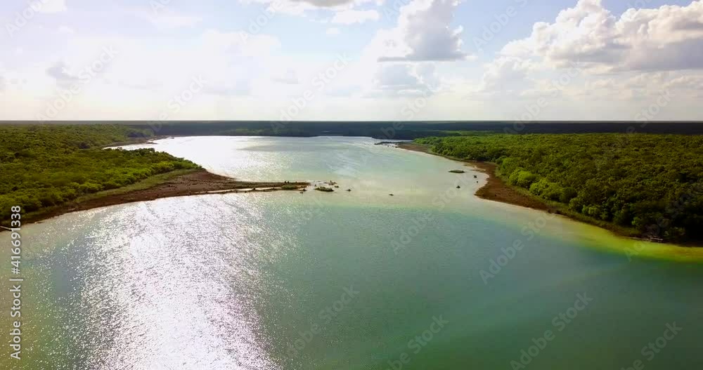 Lake aerial view in Quintana Roo from a drone camera afternoon view of nature and forest with horizon and clouds Lake aerial view in Quintana Roo from a drone camera afternoon view of nature and forest with horizon and clouds