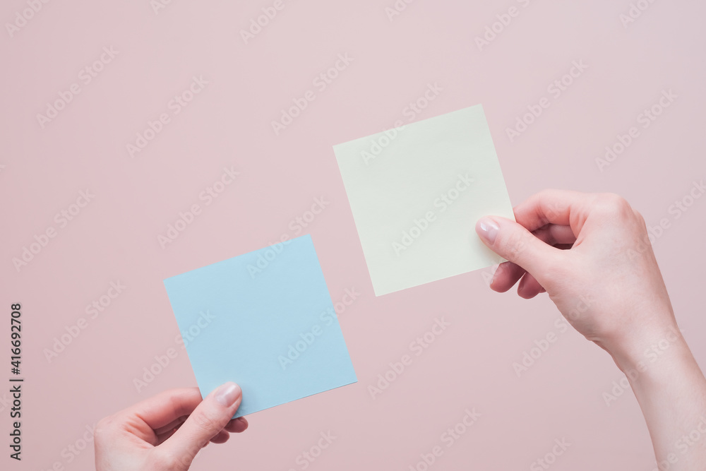 Fototapeta premium Hands holding blank sticky notes
