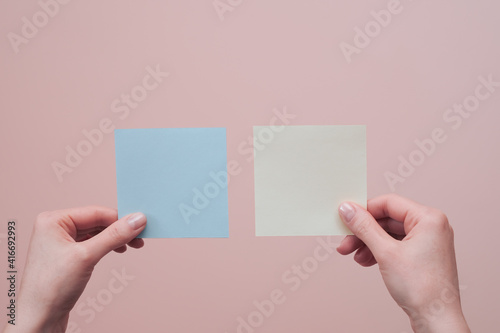 Female hands holding blank sticky post-it notes