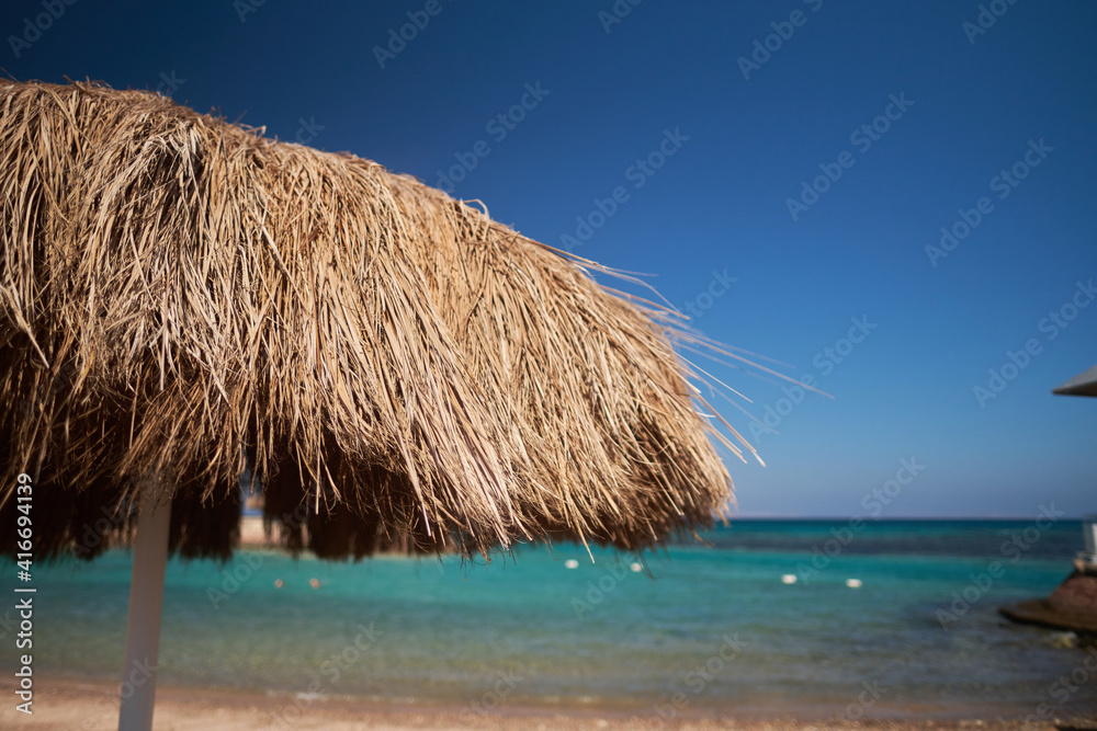 A straw umbrella on a beautiful beach A straw umbrella on a beautiful beach