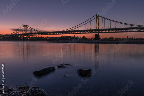 Sunset Shot Of Illuminated Historical Iron Bridge across the River Rhine at Krefeld Uerdingen