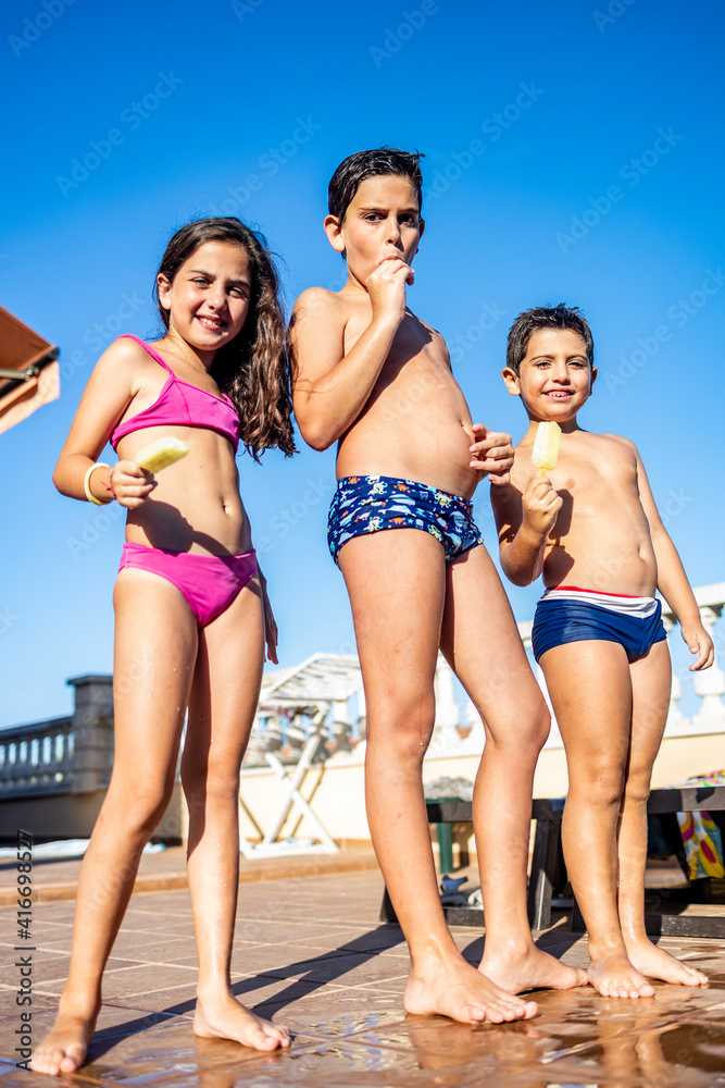 Three funny kids eating an ice lolly Three funny kids eating an ice lolly