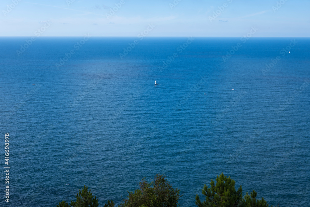 Yachts on the Atlantic ocean, deep blue water and sky.