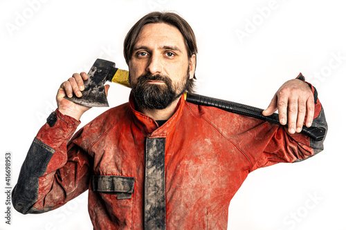 The man poses with an ax in a photo studio. photo