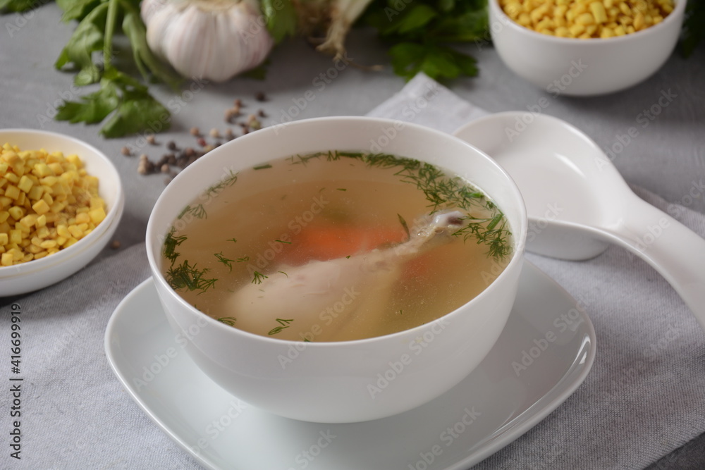 Chicken soup , chicken broth, with pieces of chicken and vegetables and shkedei marak an Israeli food product crisp mini croutons used as a soup accompaniment Chicken soup , chicken broth, with pieces of chicken and vegetables and shkedei marak an Israeli food product crisp mini croutons used as a soup accompaniment